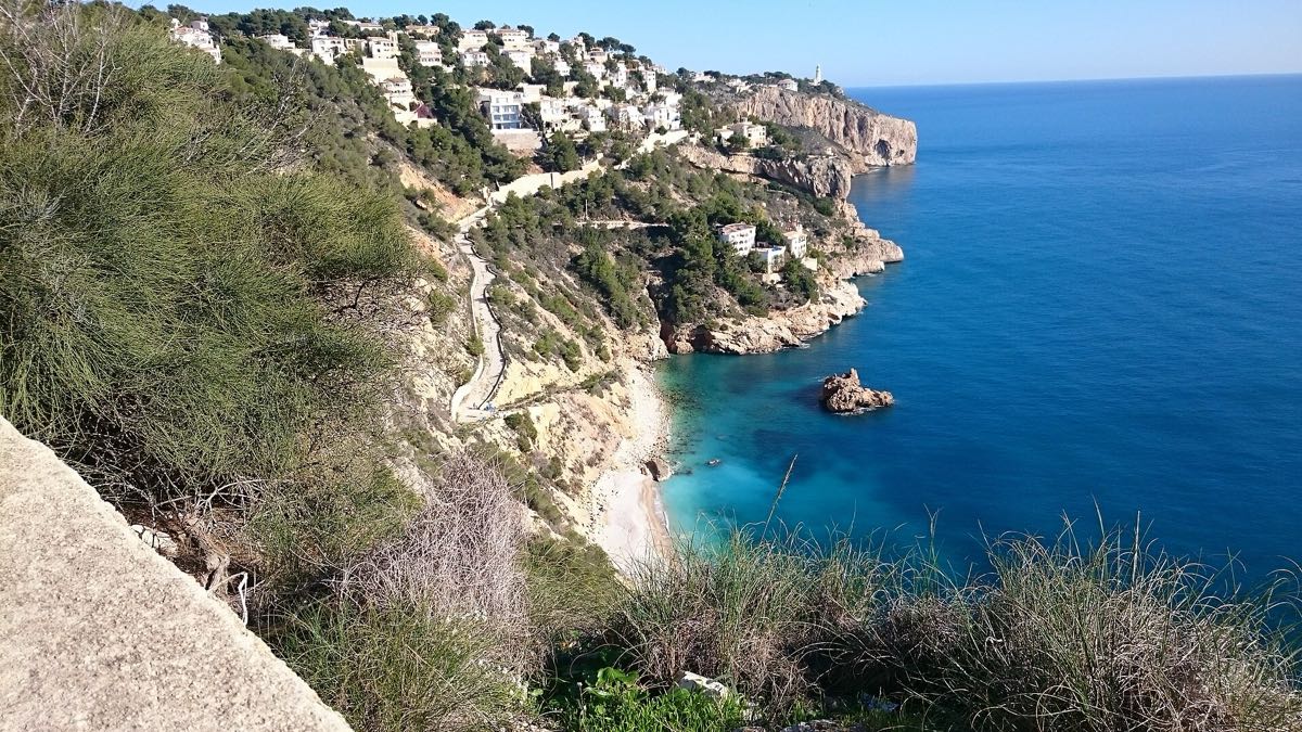 The wild cove of Cala Ambolo beneath pine-clad cliffs