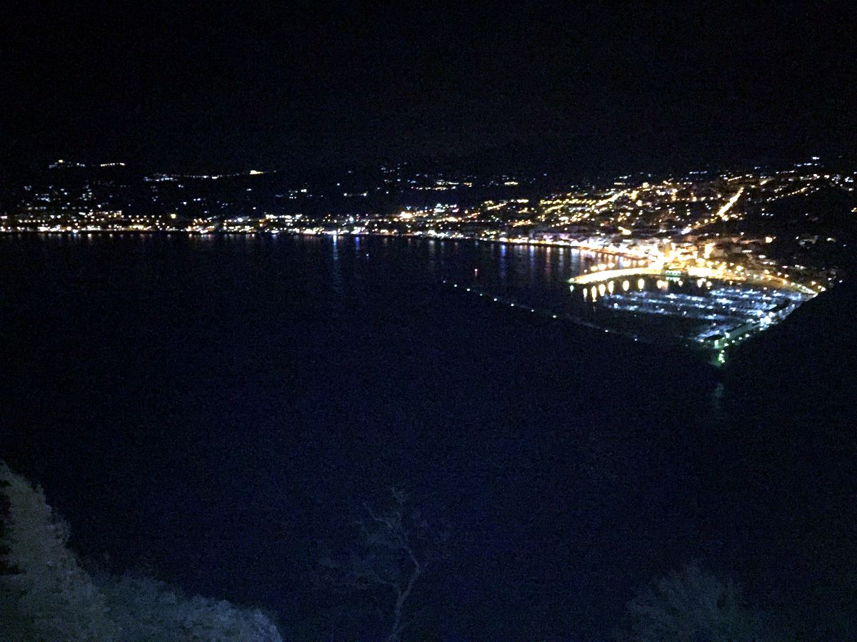 The lights of Jávea curling around the dark bay at night