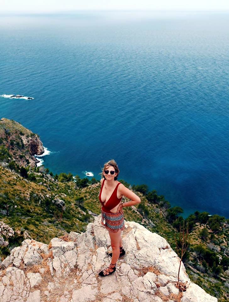 Pausing on a clifftop high above a deep-blue cove on the Jávea coast