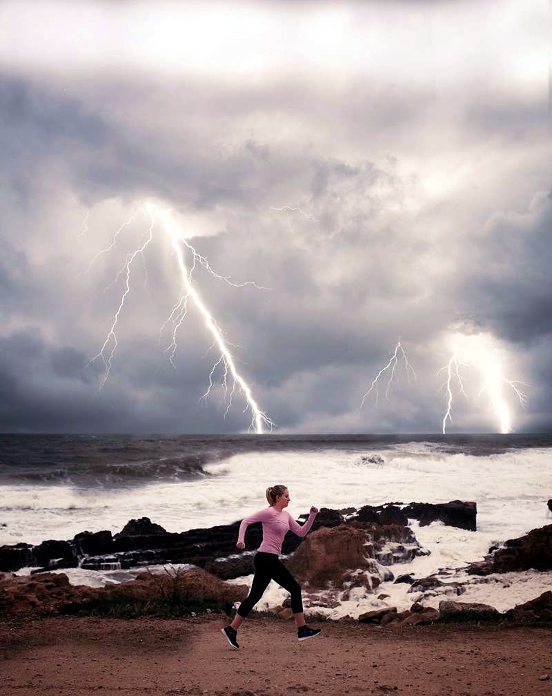 Two lightning bolts strike over a storm-dark sea off the Jávea coast