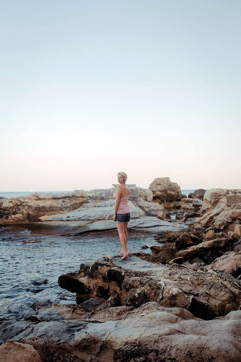 Exploring tide pools along a flat rocky stretch of the Jávea coast