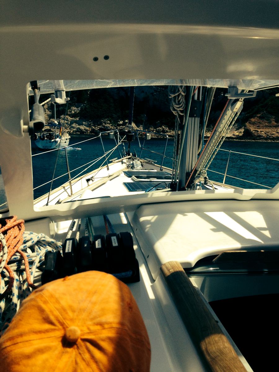 View from the deck of a sailboat off the Jávea coast, rigging in the foreground and cliffs beyond