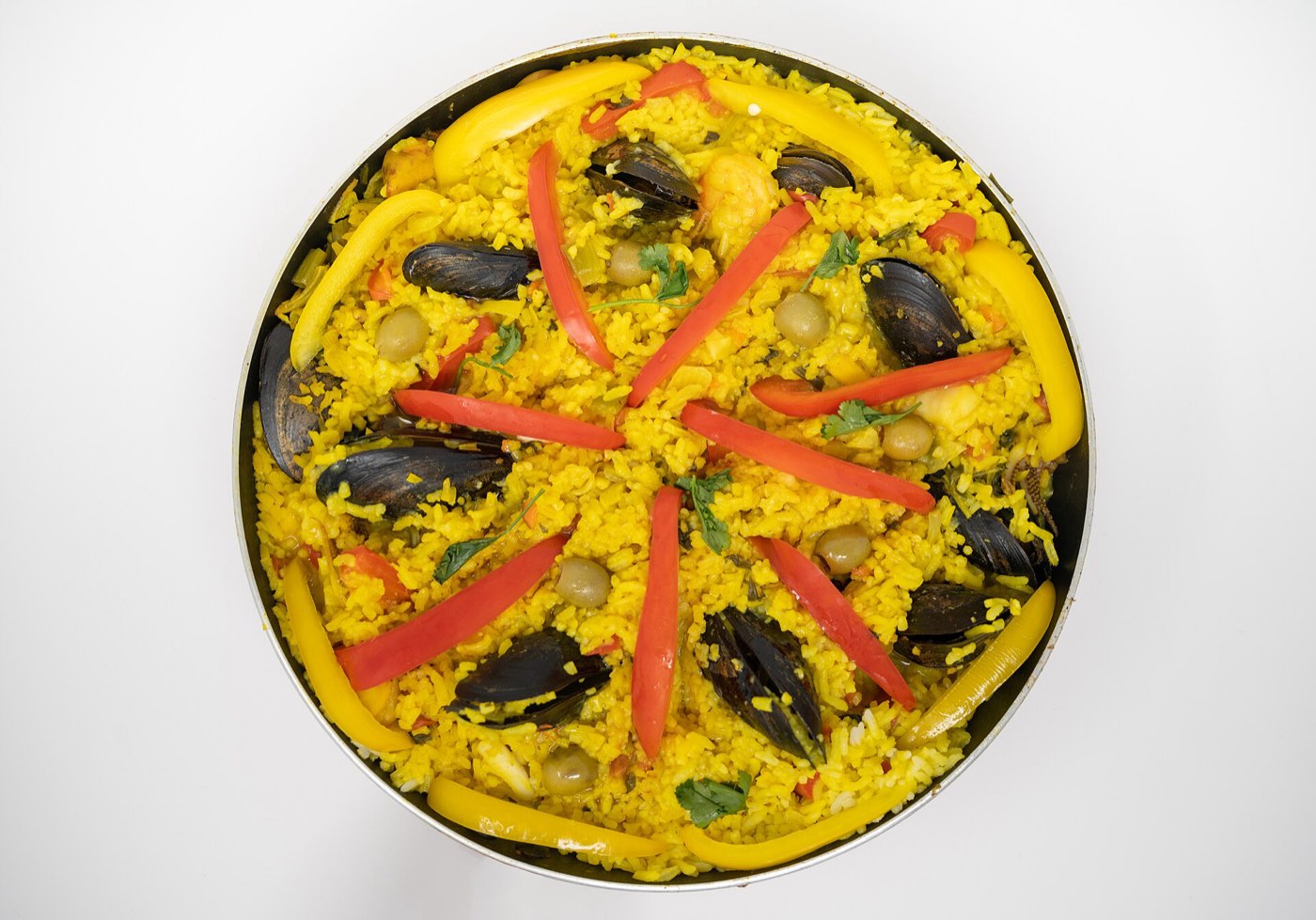 A seafood paella, saffron rice with mussels and peppers